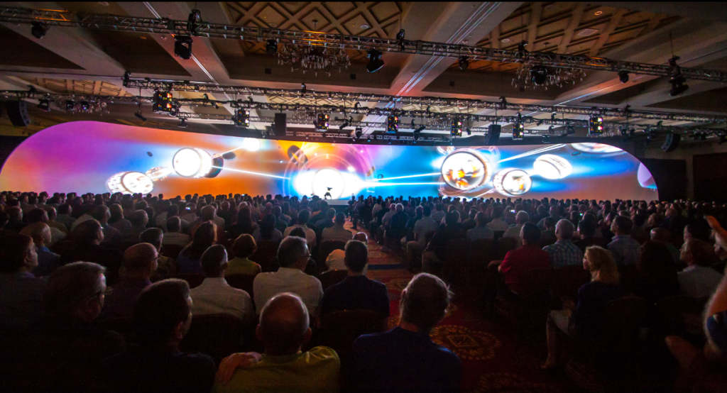 corporate conference audience watching keynote presentation during calm execution event management